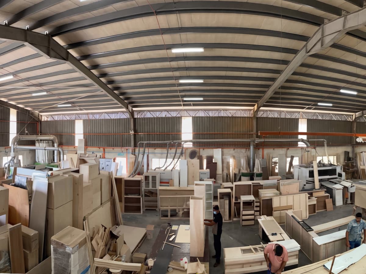 Mi Kuang carpenters building custom cabinetry in the workshop