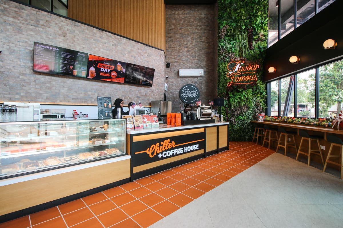 Cafe interior with greenery wall and warm hospitality finishes